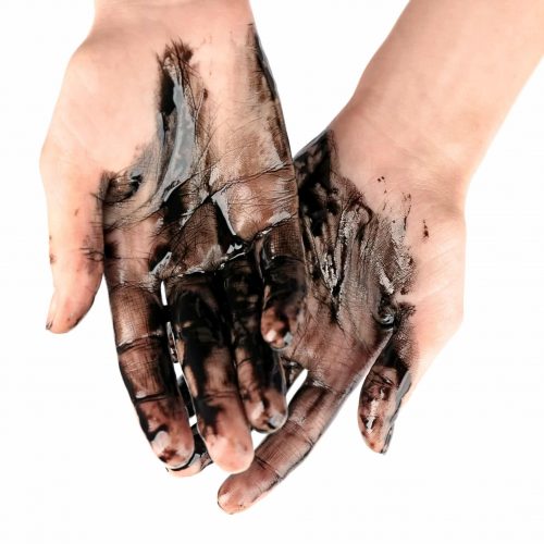 Human hands with oil on white background